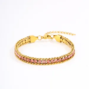 Close-up detail of the gold-tone chain bracelet featuring sparkling pink cubic zirconia stones.