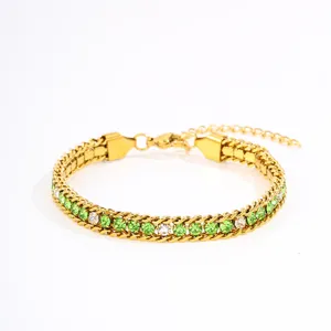 Gold titanium steel bracelet with green and clear zircon crystals and extension chain.