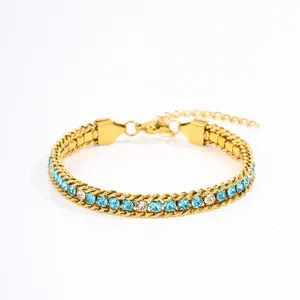 Closeup detail of the gold-tone titanium steel bracelet featuring sparkling blue and clear rhinestones.