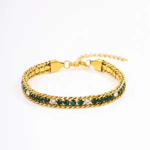 Close-up shot of gold titanium steel chain bracelet with green and white crystal stones.