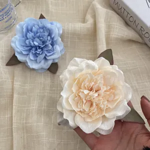 Large peony flower hair clip detail shot, fabric floral side clip for elegant beach styling.