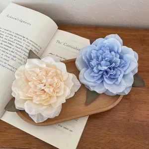 Large fabric peony flower hair clip in blue and beige, perfect for beach vacation and photo shoots.
