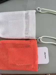 Mesh mobile phone shoulder bag detail, breathable fabric portable pouch with strap, minimalist style.