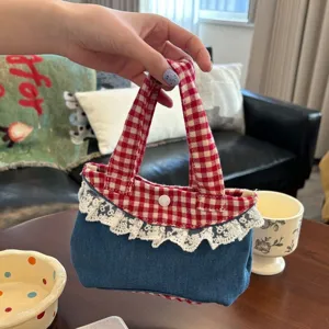 Detailed view of the Korean sweet style red plaid and denim mini handbag with lace trim.