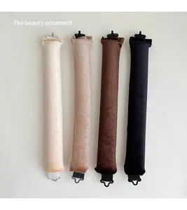Detail view of four velvet heatless hair curling rods in assorted colors for styling waves.