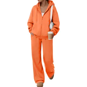 Orange fleece tracksuit set featuring a zip-up hoodie and comfortable wide-leg sweatpants.