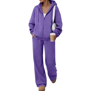 Detail view of the purple fleece tracksuit showing soft texture, zipper and pocket features.