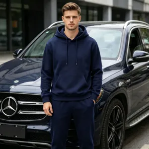 Detailed view of men's solid color fleece-lined hoodie and sweatpants tracksuit set.