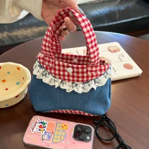 Detailed shot of Korean sweet gingham denim handbag with white lace trim and double handles.