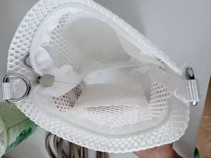 Detailed view of white mesh crossbody phone bag interior showing zipper and pocket structure.