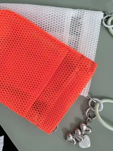Portable mesh phone shoulder bag with cute heart keychain, minimalist style everyday cosmetic pouch.