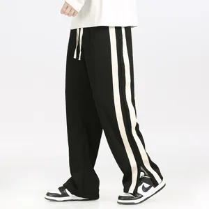 Close-up of men's casual loose straight pants with double side stripes and drawstring waist.