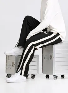 Men's loose casual straight trousers with bold stripes and drawstring waist, detailed fit view.