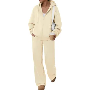 Detail view of beige fleece zip-up hoodie and wide-leg sweatpants set, cozy casual wear.