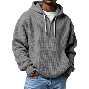 Men's casual grey waffle knit quarter-zip hoodie with adjustable drawstring hood and pocket.