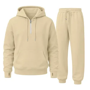 Detail shot of casual beige half-zip hoodie and sweatpants set with thumb holes and drawstring.