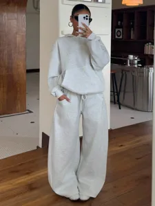 Detail shot of cozy fleece hoodie and wide leg sweatpants set, casual street style outfit.