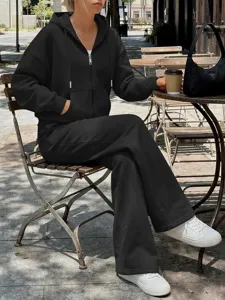 Vista dettagliata di un set di felpa con cappuccio e pantaloni neri da donna in stile streetwear.