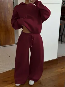 Burgundy fleece tracksuit detail view, stylish casual two-piece hoodie and wide-leg pants.