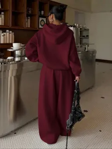 Women fleece tracksuit set oversized hoodie and casual sweatpants, burgundy street wear.