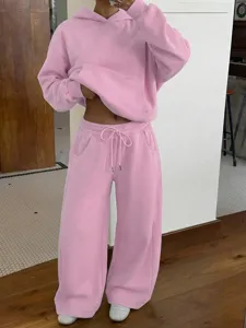 Pink fleece hoodie and wide leg sweatpants detail shot, casual two piece set outfit view.