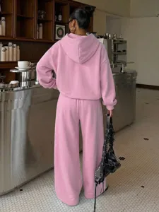 Back detail of women pink fleece hoodie and wide leg sweatpants tracksuit set casual street style.
