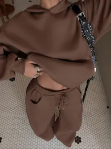 Women casual fleece hoodie and sweatpants tracksuit set brown streetwear outfit.
