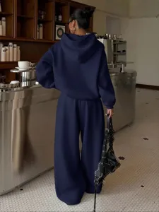 Casual women's fleece hoodie and wide leg sweatpants two piece set streetwear outfit.