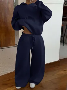 Detail shot of women's navy blue fleece hoodie and matching sweatpants tracksuit set.