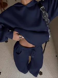 Detail view of dark blue fleece hoodie and matching streetwear set showing fabric texture.