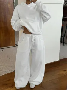 Detailed view of women's white casual hoodie and sweatpants sportswear set, fleece lined.