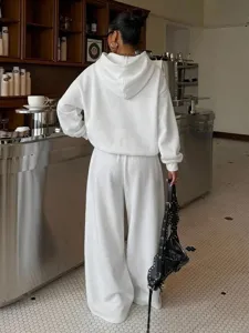 Detail shot of women fleece tracksuit two-piece set, casual hooded sweatshirt and wide-leg pants.