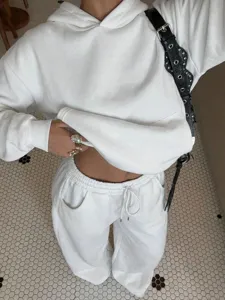 Detailed view of white fleece tracksuit, casual hooded sweatshirt and matching pants.