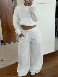 Close-up detail shot of the casual white fleece hoodie and sweatpants outfit in daily scene.