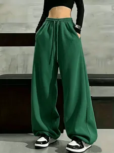 Women's dark green loose wide-leg fleece sweatpants with high waist and casual drawstring design.