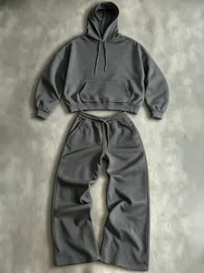 Detail view of dark grey hoodie and wide-leg sweatpants set, cozy texture, casual design.