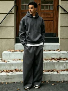 Mens fleece hooded sweatshirt and wide leg sweatpants set casual outfit detail view.