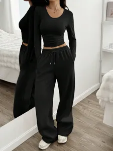 Vue détaillée de la tenue pour femmes avec haut noir à manches longues et pantalon.