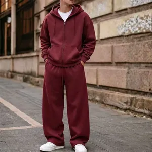 Street style detailed view of a solid color zip hoodie and wide leg sweatpants outfit.