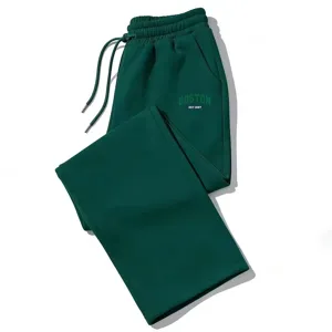 Green wide-leg sweatpants for men and women, with comfortable drawstring waist and letter print.