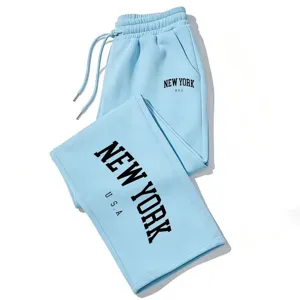 Light blue drawstring sweatpants with New York letter print, casual loose streetwear joggers.