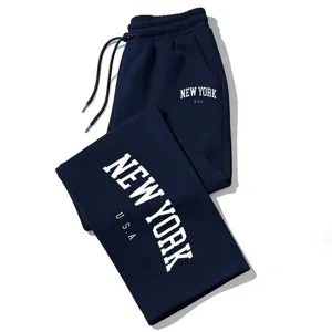 Dark blue sweatpants detail showing white New York letter print and adjustable drawstring waist.