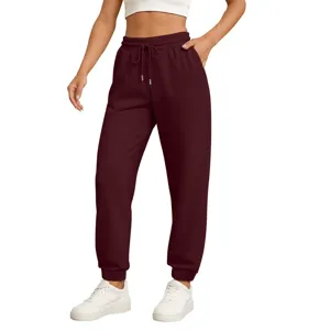 Comfortable burgundy sweatpants for women, featuring elastic cuffs and adjustable drawstring.