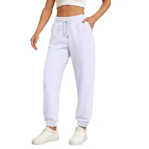 Close-up detail of casual white sweatpants with drawstring and elastic cuffs for daily wear.