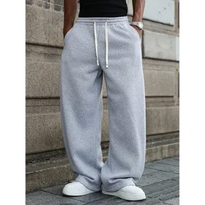 Detailed shot of casual loose grey sweatpants for men, featuring comfortable drawstring waist.