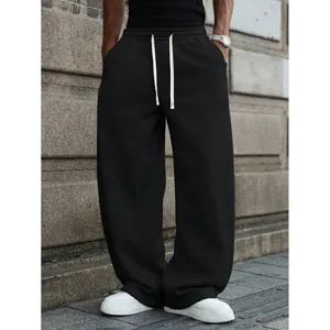Mens black wide leg sweatpants casual streetwear loose fit athletic trousers with white drawstring.