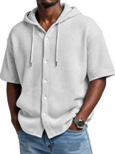 Detailed view of men's waffle knit short sleeve hoodie with buttons and casual streetwear style.