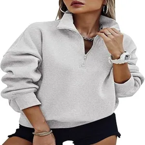Half zip pullover sweatshirt detail, grey long sleeve top collar view and ribbed hem.