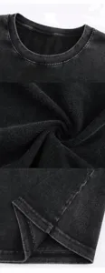 Close up detail view of vintage washed black cotton t shirt showing fabric texture and collar.