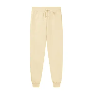 Detailed view of beige fleece sweatpants with drawstring waist and elastic cuffs.